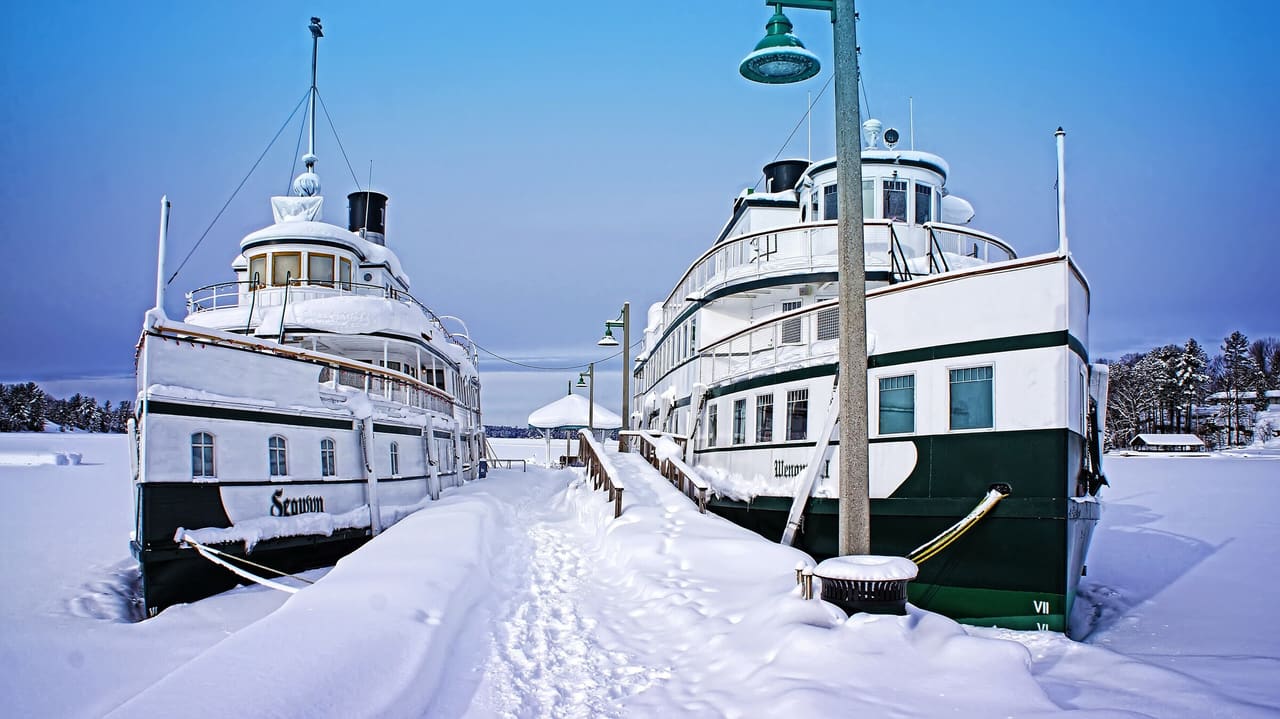 The steamships RMS Segwun and Wenonah II tied up at a snow-covered wharf in Muskoka.